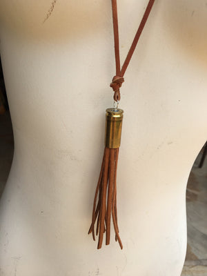 Jewelry, bullet with leather fringe on leather rope.